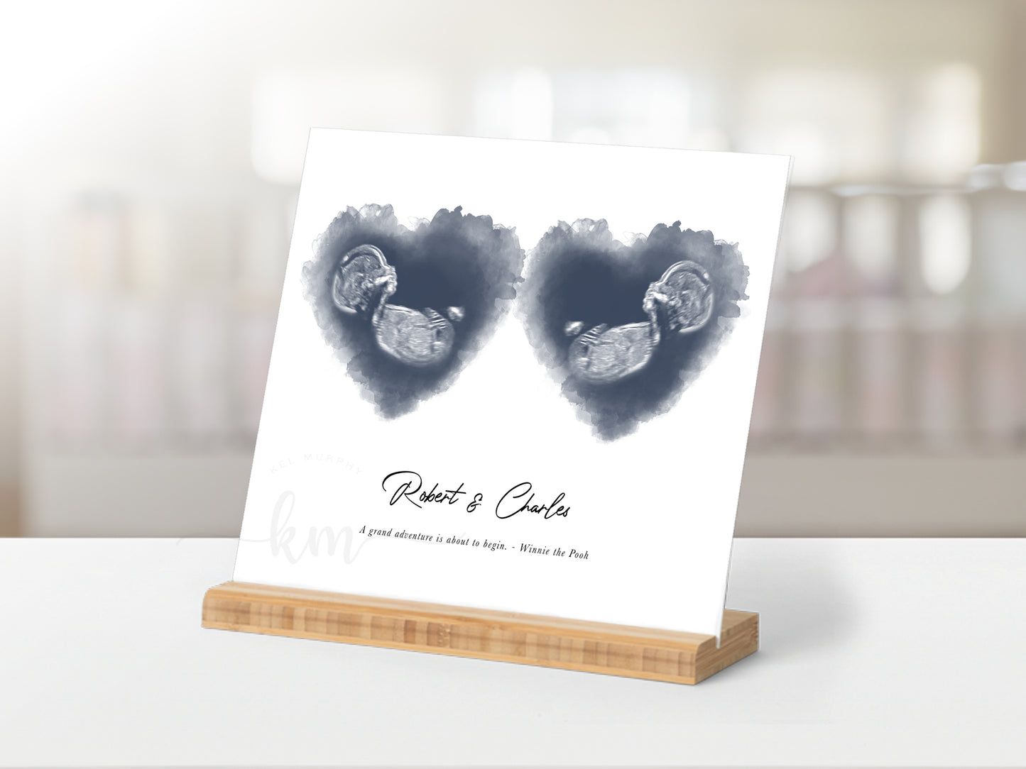 Baby keepsake with twin ultrasound images inside watercolor hearts

